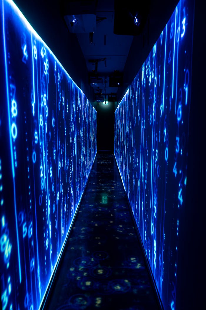 services-04 A luminous blue tunnel with digital numbers creating a futuristic, sci-fi ambiance.